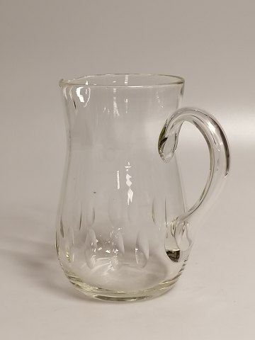 Glass jug with olive grinds